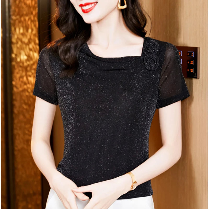 Black shimmer short-sleeve top with a square neckline and decorative floral detail on the shoulder.