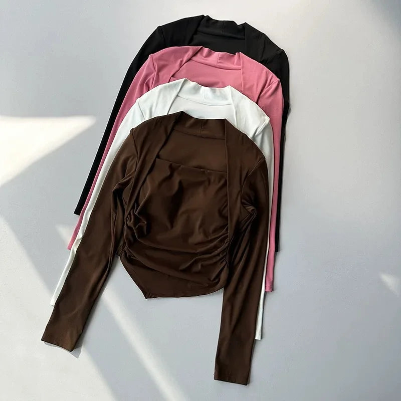 Four long-sleeved, square-neck tops in black, pink, white, and brown, featuring ruched sides and slim-fit styling.