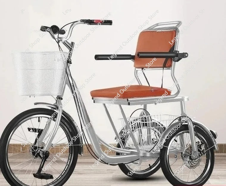 Silver adult tricycle with brown padded seat, backrest, armrests, front basket, and rear cargo basket.