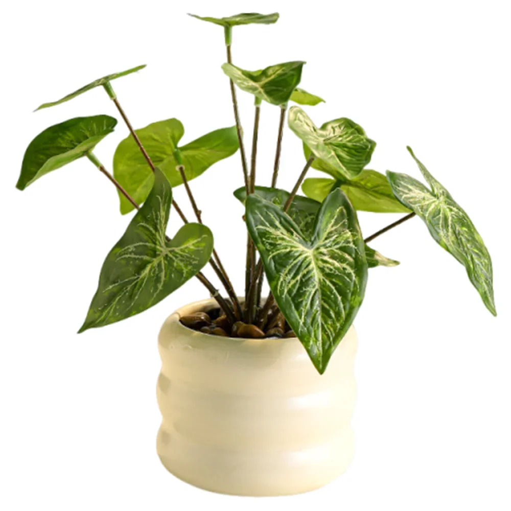 Artificial potted plant with heart-shaped, variegated green leaves in a ribbed cream ceramic pot with smooth stones.
