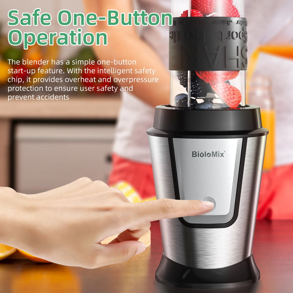 Silver personal blender with black trim and a one-button design, shown filled with berries and being operated.