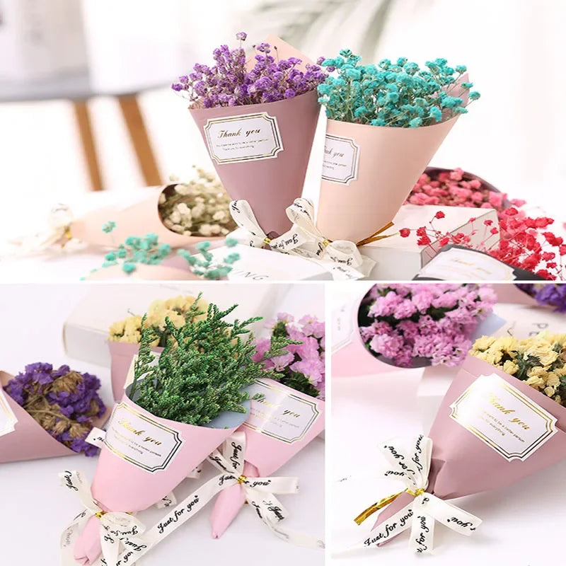 A selection of colourful dried flower bouquets wrapped in pink paper with 'Thank You' labels and ribbon bows.