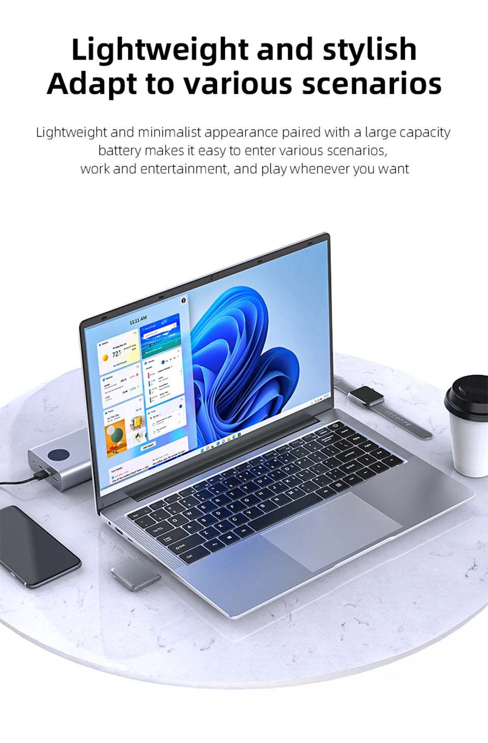 A slim, silver 14.1-inch laptop with a backlit keyboard on a marble table with office accessories.