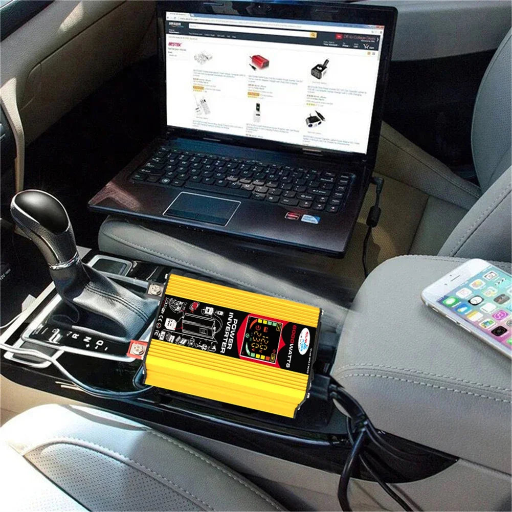 Bright yellow 6000W power inverter with dual USB ports and digital display, sitting in a car interior.