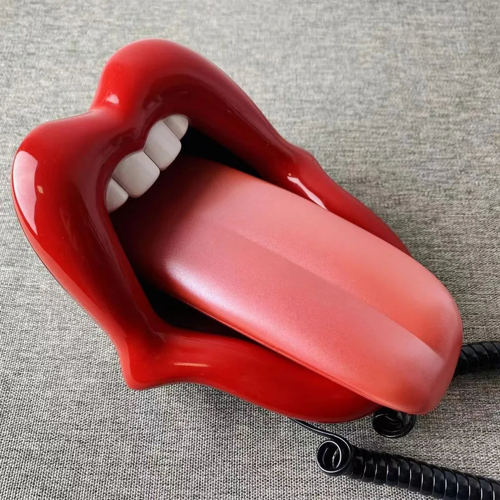 Retro novelty landline phone shaped like bright red lips with white teeth and a long tongue handset.