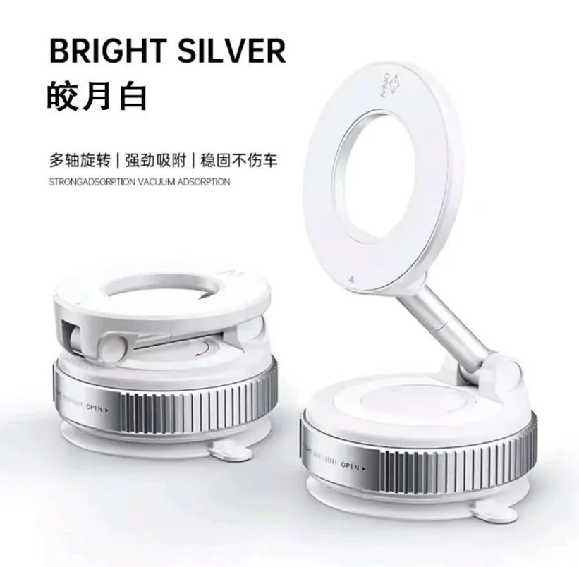A silver and white vacuum-adsorption car phone holder, shown folded and extended with an adjustable circular head.