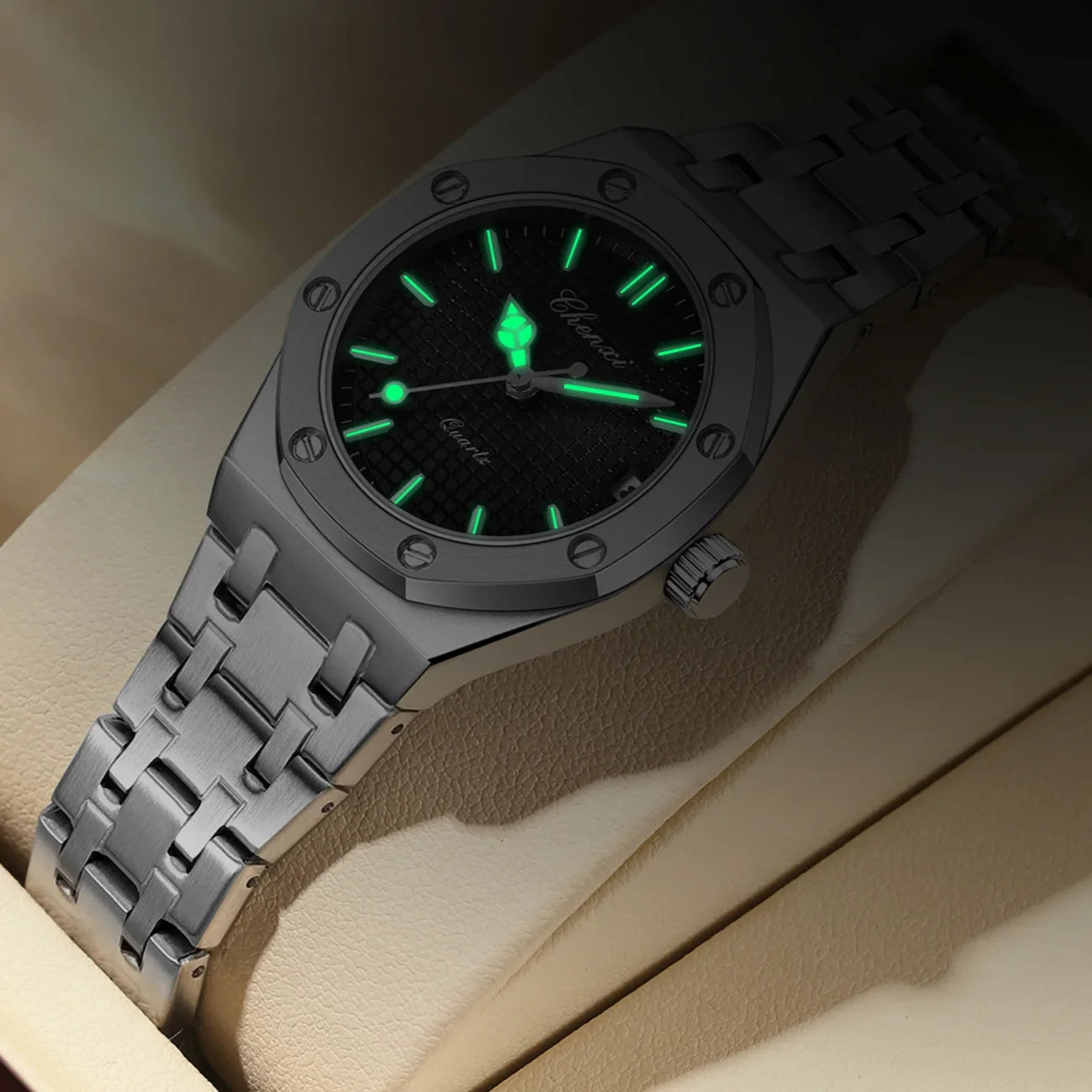 Luxury silver stainless steel women's analogue watch with a textured black dial and glowing hands and hour markers.