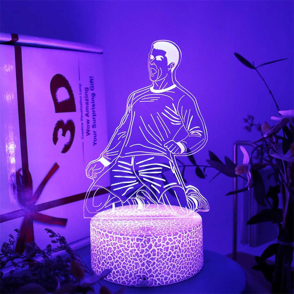 3D LED lamp featuring a footballer celebrating, emitting a vibrant purple glow from a textured, illuminated base.
