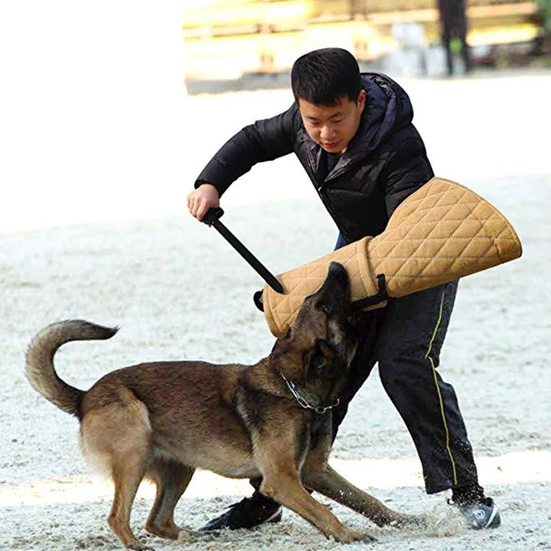 Tan jute dog bite training sleeve with a handle, worn on the arm during dog training.