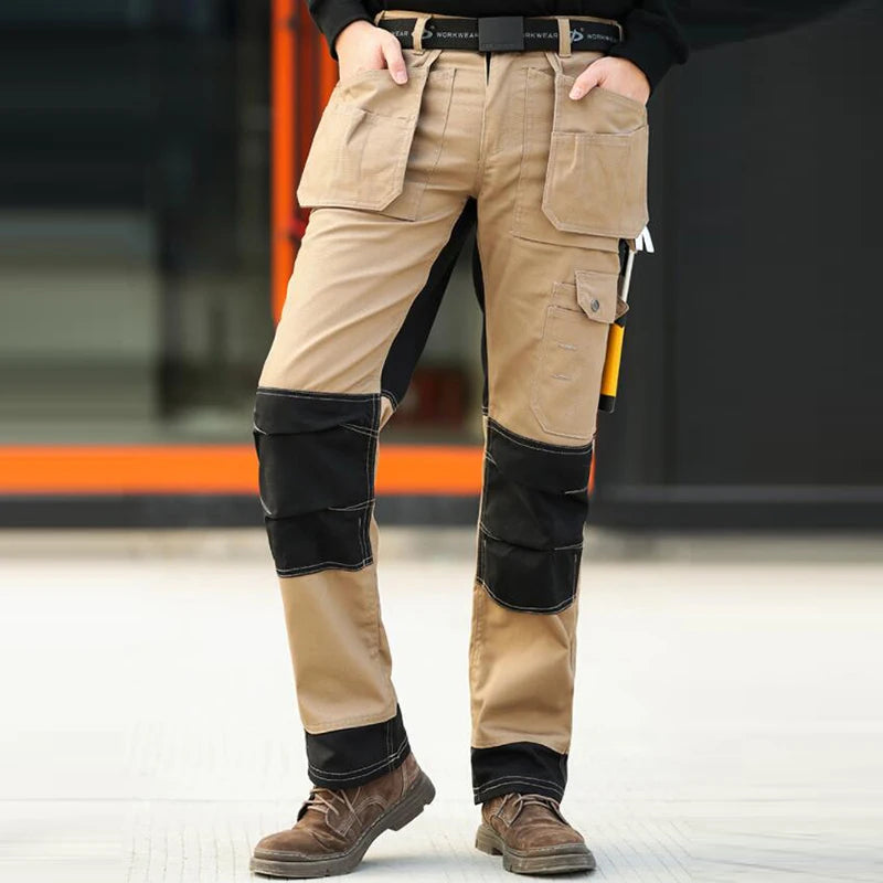 Men’s khaki and black cargo work trousers featuring multiple utility pockets and reinforced knee panels.