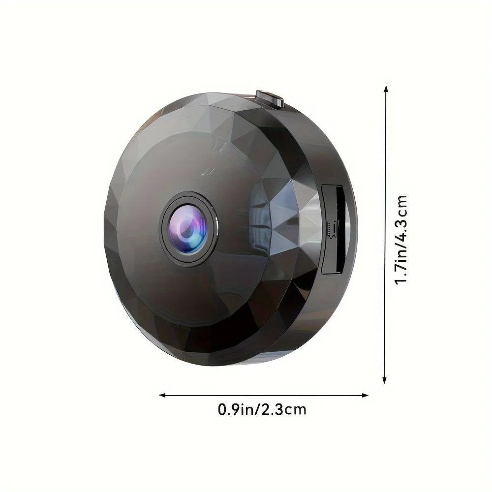 Black circular plastic mini security camera with a faceted surface, central lens, and side SD card slot.