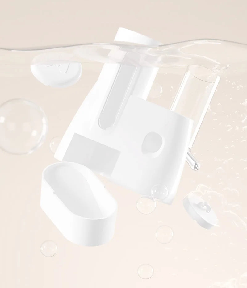 White, minimalist modular oral irrigator components floating in water with bubbles against a soft beige background.