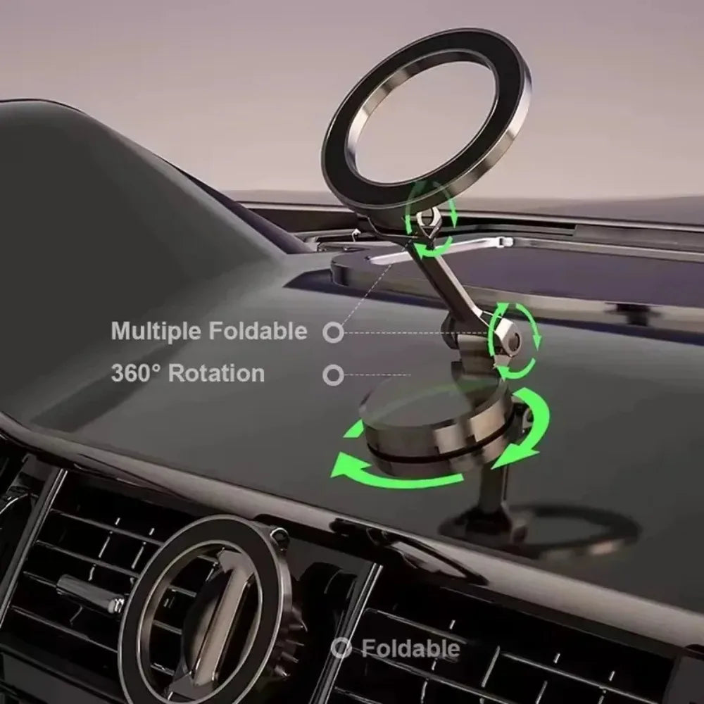 Foldable, metallic grey magnetic car phone mount on a dashboard with 360-degree rotation and adjustable folding hinges.