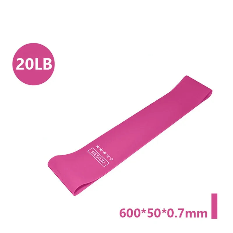 Pink medium resistance loop band, labelled 20LB, measuring 600x50x0.7mm.