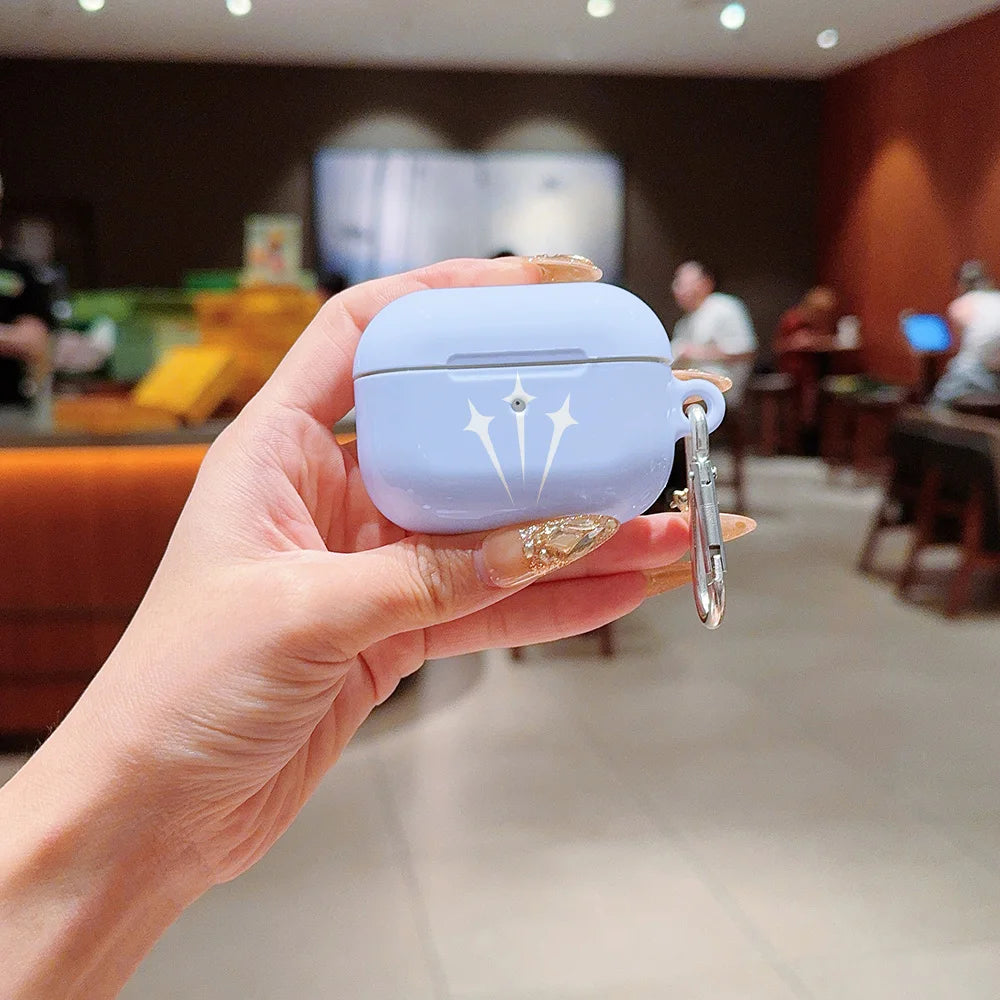 Pastel blue silicone AirPods Pro case with white star design and silver carabiner held in a hand.