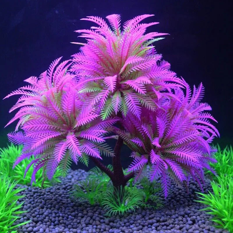 Artificial aquarium plant with vibrant purple and green fern-like fronds on a dark trunk, set against a black backdrop.