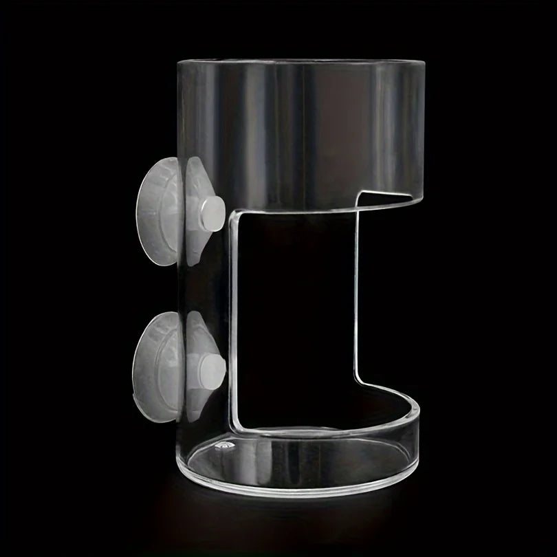 Clear acrylic cylindrical shower caddy with two suction cups for mounting, set against a black background.