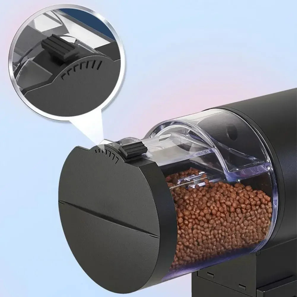 Matte black automatic pet feeder with a clear, cylindrical food hopper filled with brown dry kibble.