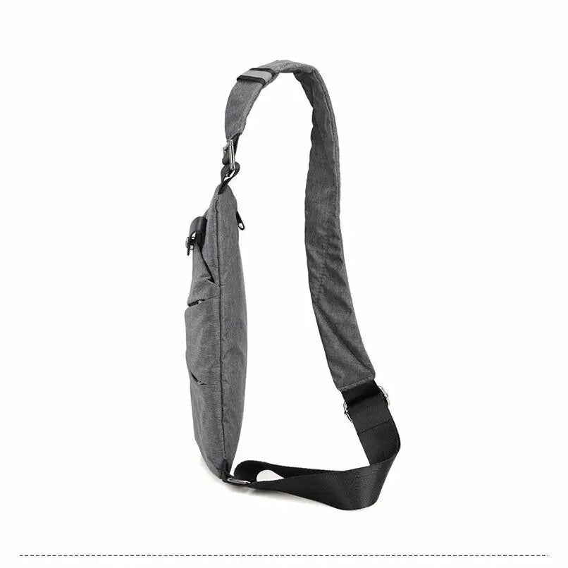 Side view of a slim grey men's crossbody chest bag with an adjustable black shoulder strap.