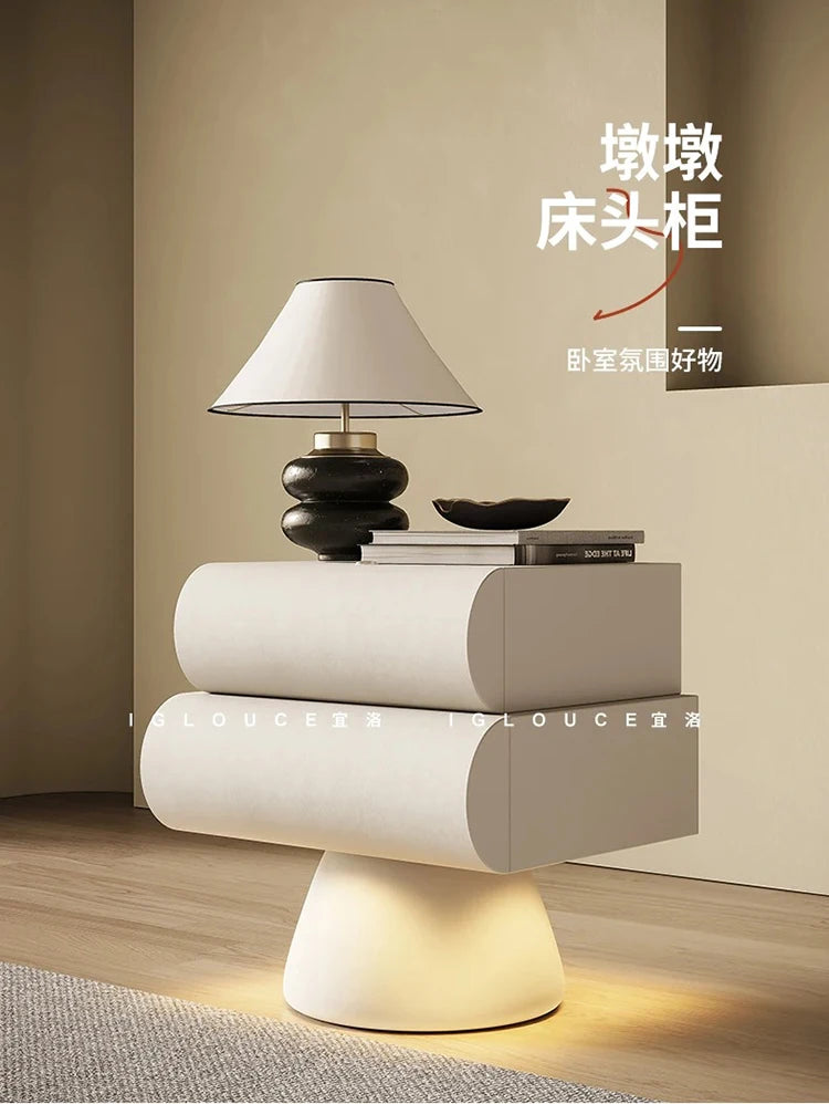 Modern cream floating-style bedside table with two rounded drawers and an integrated illuminated pedestal base.