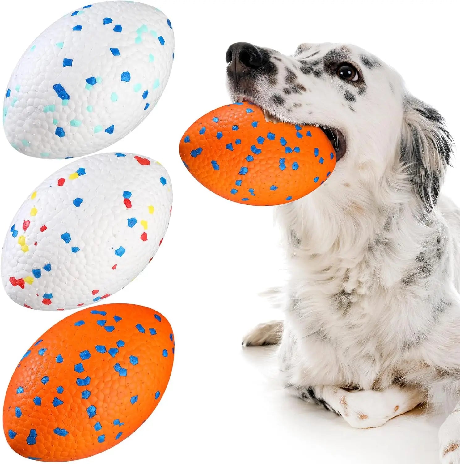 A white dog holding an orange textured football toy. Includes three egg-shaped dog toys in orange and white speckle.