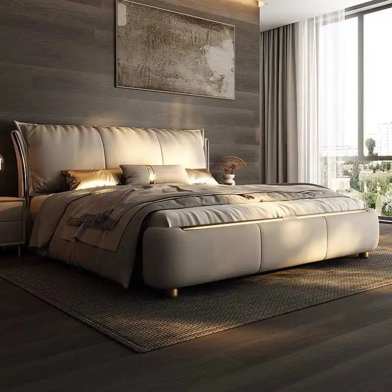 Modern beige double bed frame with a padded, curved headboard, upholstered finish, and gold metallic accents.