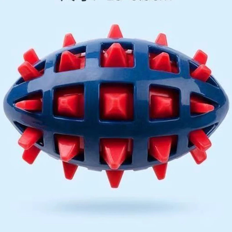 Durable navy blue rubber rugby ball dog toy with a red grid design and protruding spikes for dental stimulation.