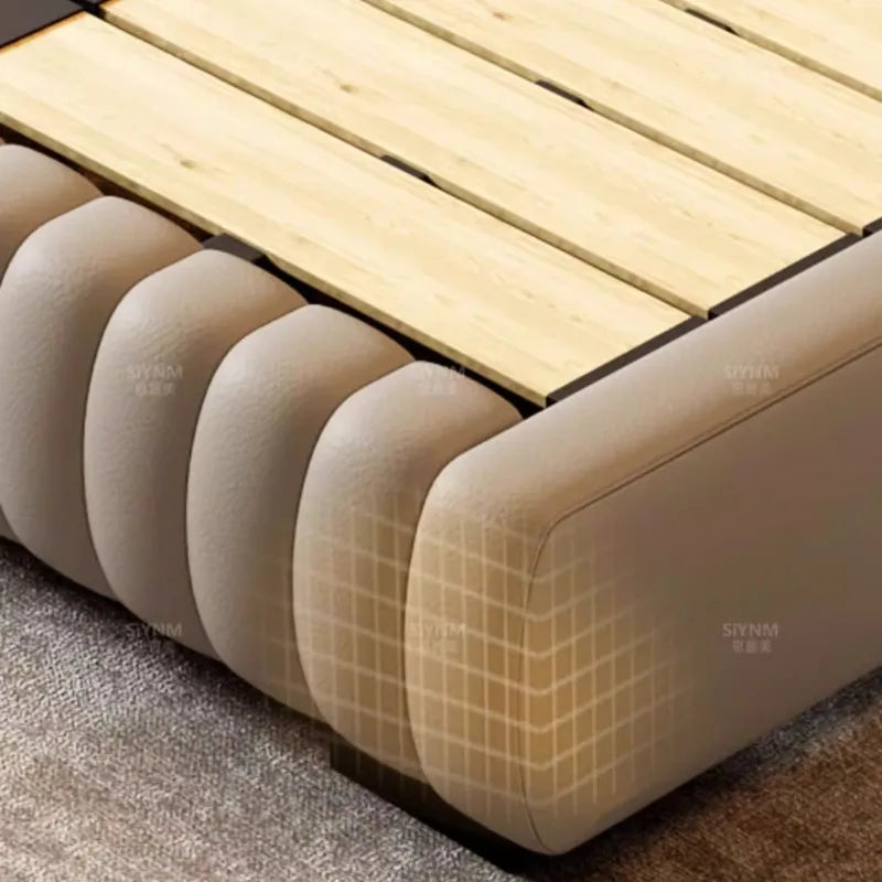 Modern cream storage bed frame with cushioned, panelled sides and a sturdy wooden slatted base.