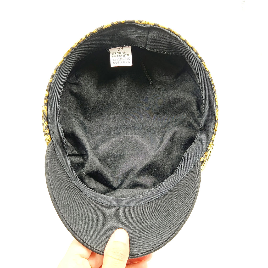 Inside view of a leopard-print beret hat with a black peak and black fabric lining.