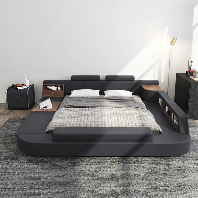 Modern dark grey upholstered low-profile bed with integrated wooden shelving, side storage and a flat surface.