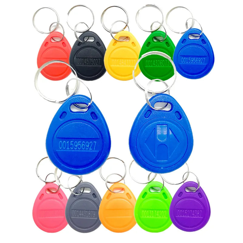Multicolor plastic RFID key fob tags with metal rings, each printed with a unique ID number.