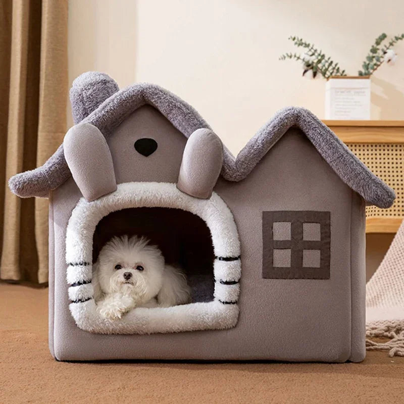 Gray plush foldable pet cave house with fluffy white trim, a chimney, and a small white dog inside.