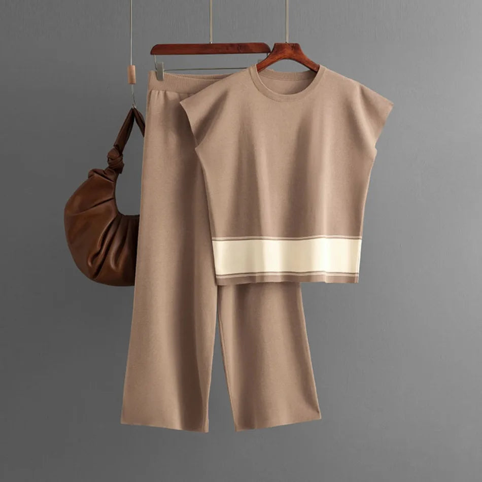 Taupe knit loungewear set featuring a short-sleeve top with cream hem stripe and wide-leg trousers.