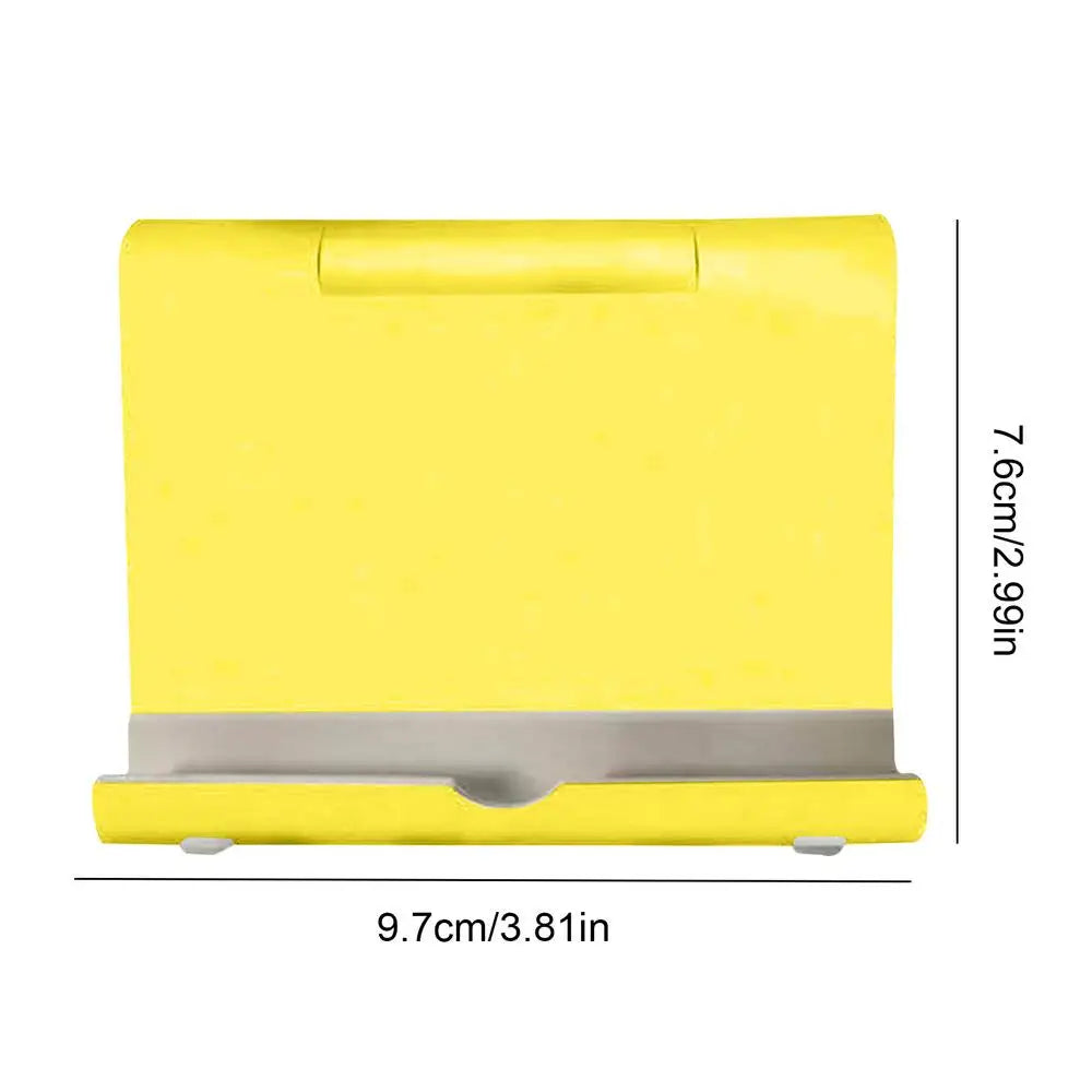 Bright yellow folding mobile phone or tablet stand with a grey non-slip ledge, measuring 9.7cm by 7.6cm.