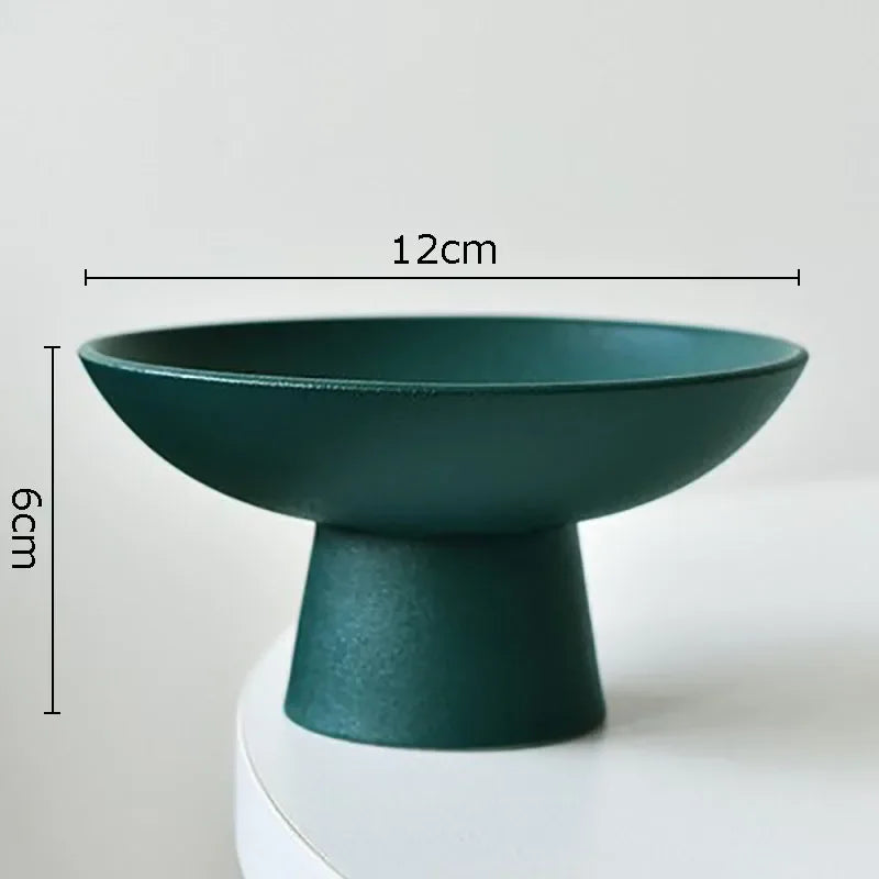Dark green decorative pedestal bowl with a matte finish, 12cm diameter and 6cm height. Minimalist tabletop design.