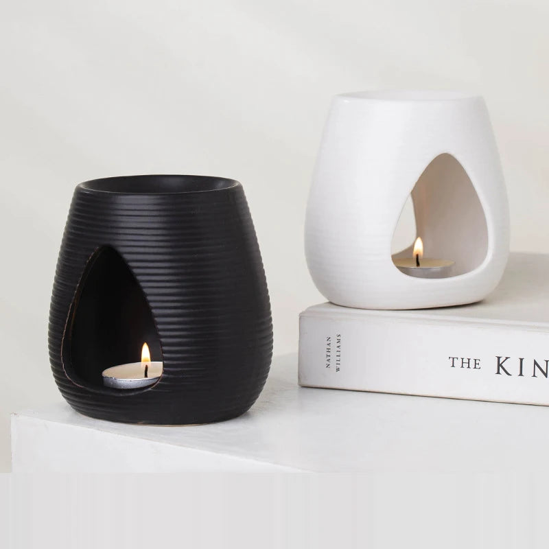 Black and white ribbed ceramic wax melt burners with cut-out tealight compartments.