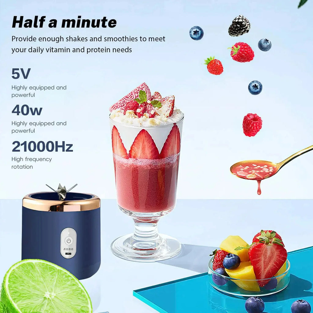 Dark blue portable blender with metallic gold trim, displayed next to a glass of strawberry smoothie and fresh fruit.