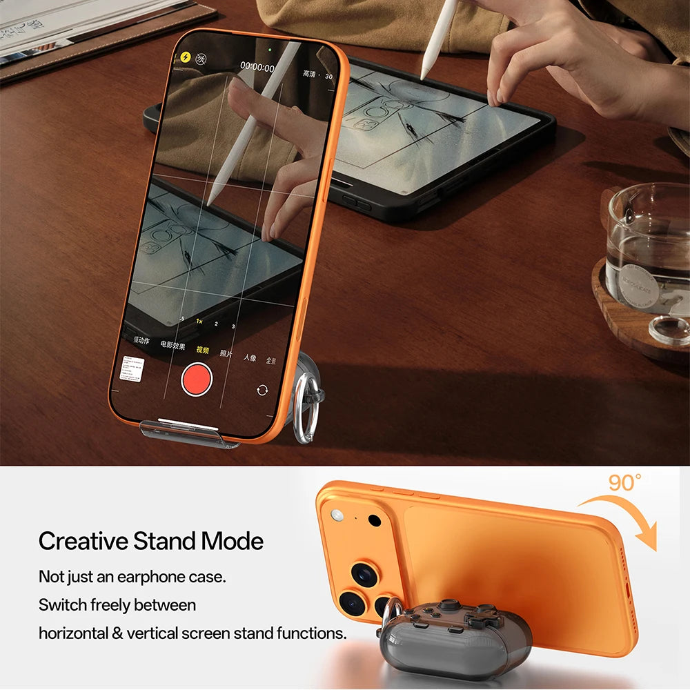 Translucent grey AirPods Pro case with built-in metal ring stand, propping up an orange smartphone.