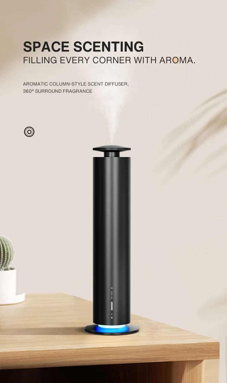 A sleek, black cylindrical aroma diffuser on a wooden desk, emitting a fine mist with a glowing blue base light.