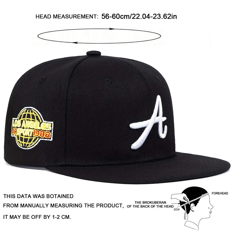 Black baseball cap featuring a white gothic letter 'A' on the front and an embroidered globe patch on the side.