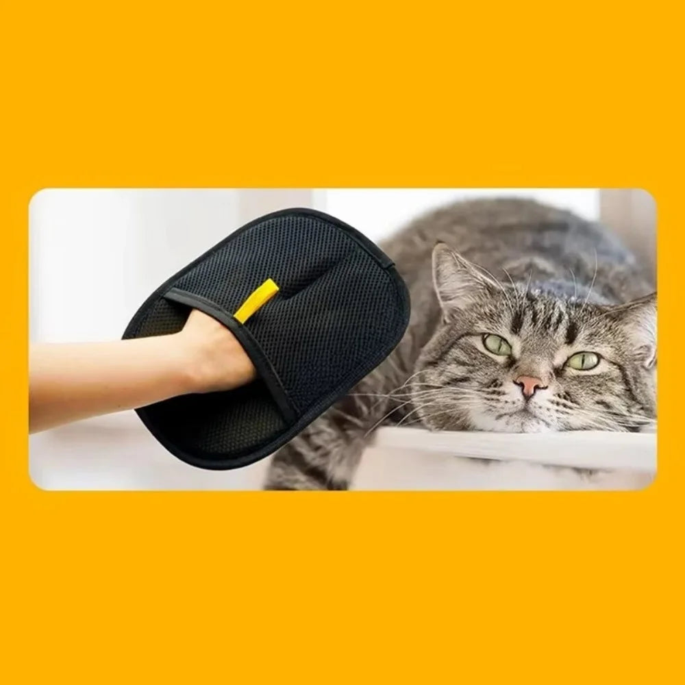 A hand wearing a black mesh pet grooming mitt, positioned next to a relaxed tabby cat.