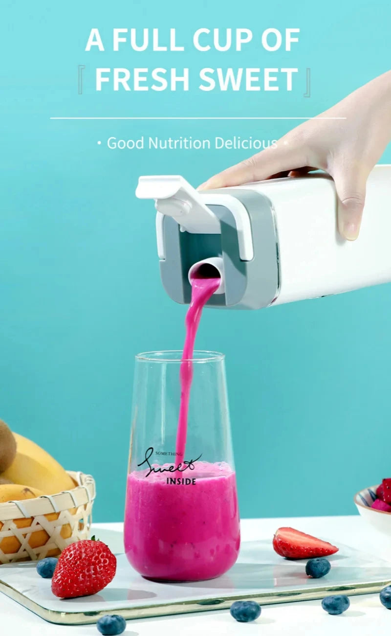 A white portable blender pouring a vibrant pink smoothie into a glass on a table with fresh fruit.