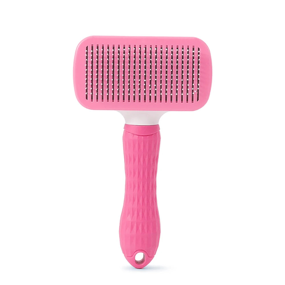 Pink pet slicker brush with a textured handle and fine metal pins, set against a plain white background.