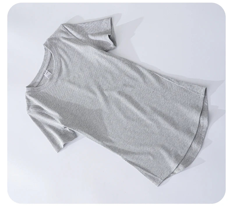 Grey short-sleeved t-shirt in a textured, ribbed fabric with a round neckline and curved hem on a white background.