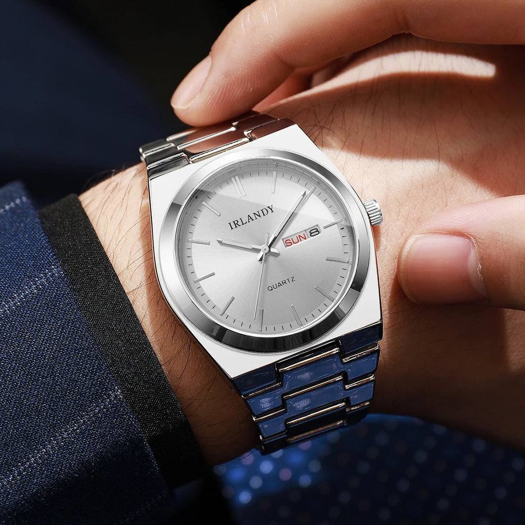 Luxury men’s silver-tone quartz watch with a minimalist face, day-date display, and polished stainless steel strap.
