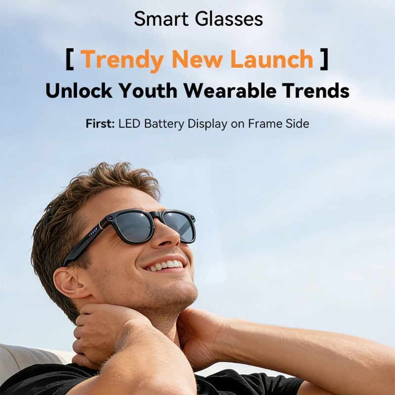 A man wearing sleek, black smart glasses with an integrated camera and a side LED battery display.