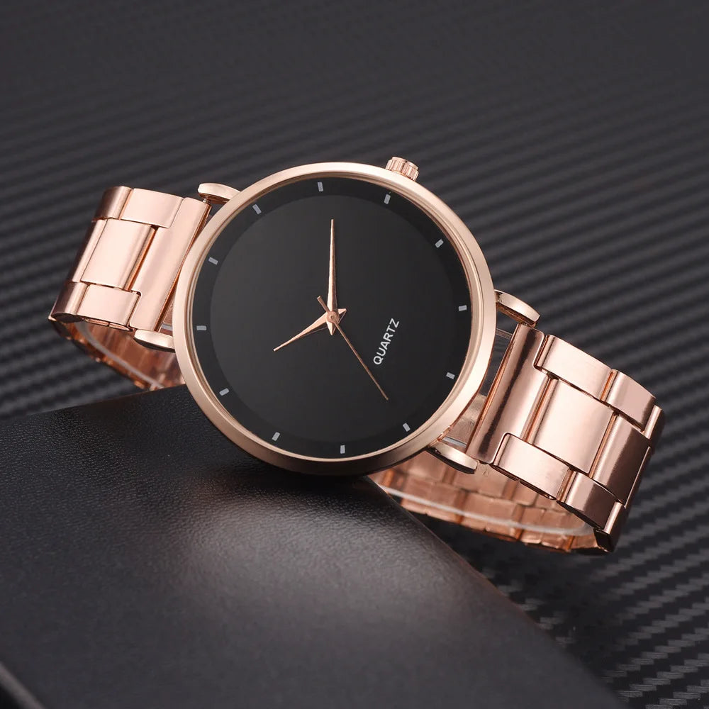 Elegant ladies' rose gold stainless steel watch with a round black dial and minimalist hour markers.