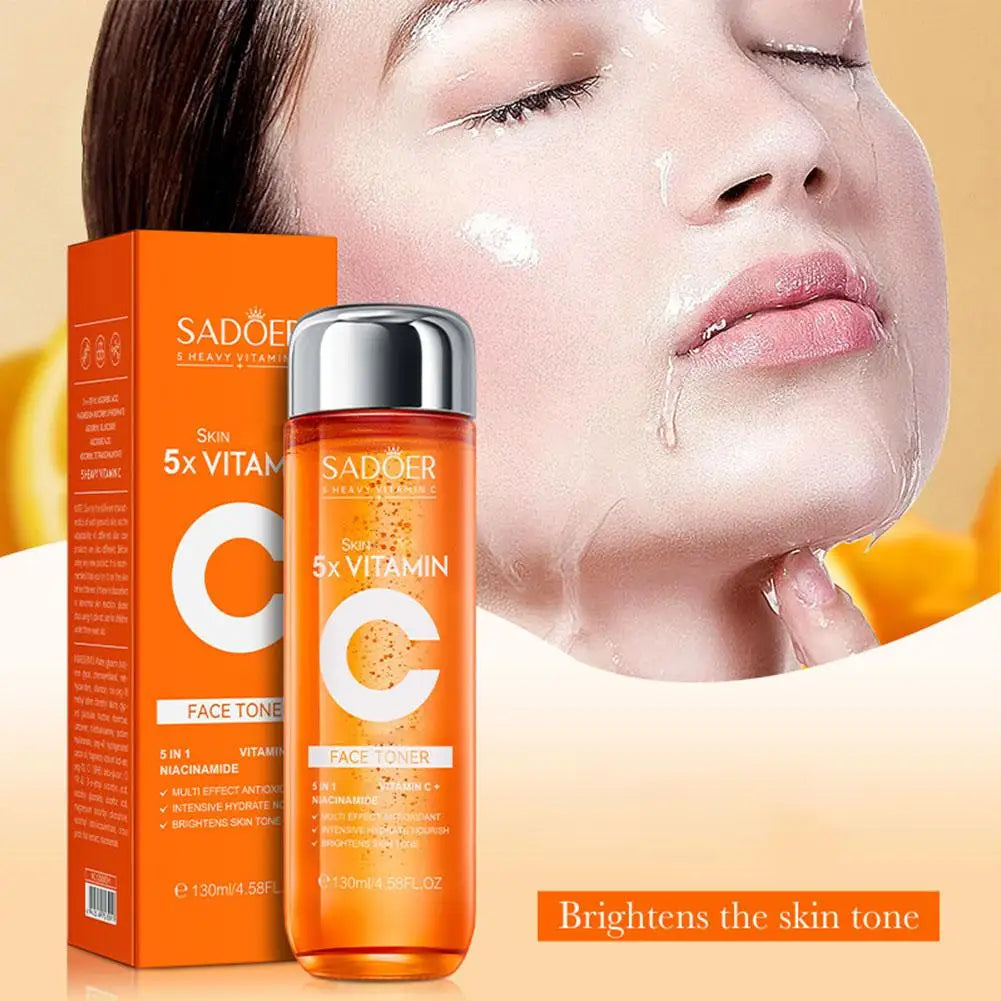 Orange bottle of 5x Vitamin C face toner with box, featured next to a woman applying hydrating, brightening skincare.