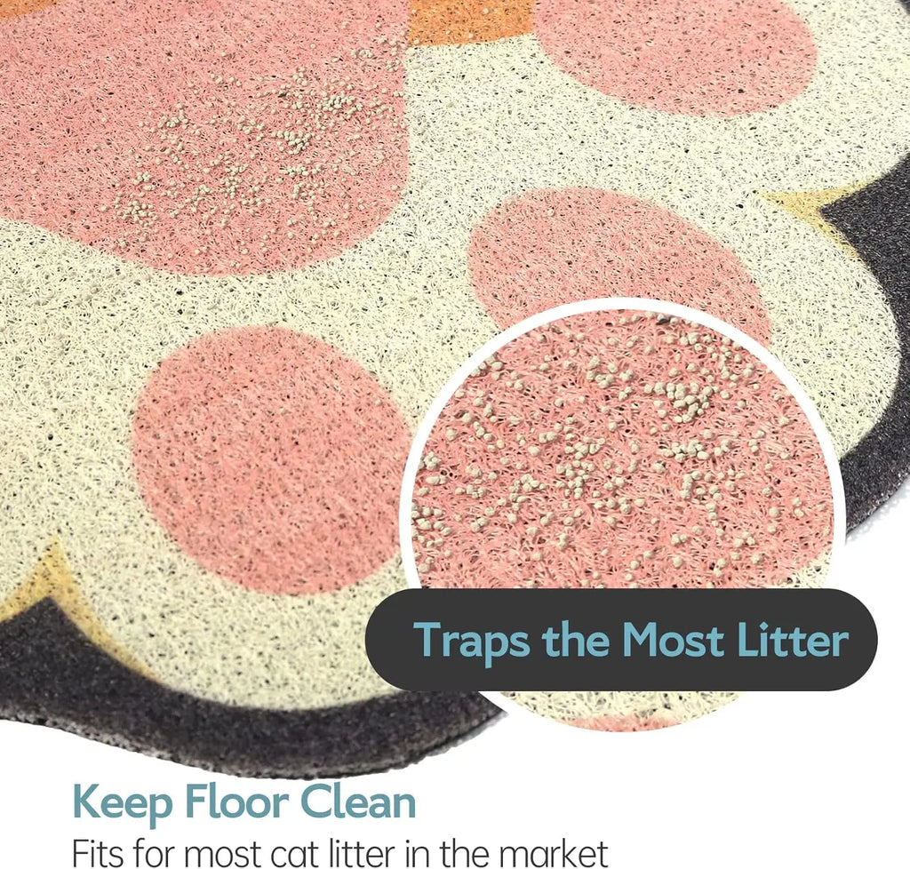 Paw-shaped anti-slip cat litter mat in cream and pink, featuring a textured mesh surface to trap stray litter grains.