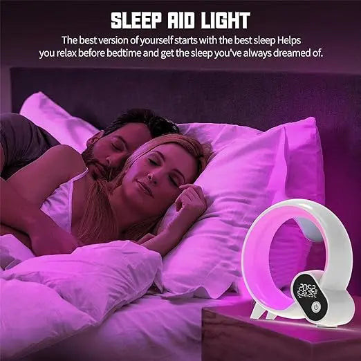 Modern white, ring-shaped smart LED wake-up light and alarm clock glowing with a soft pink light on a bedside table.